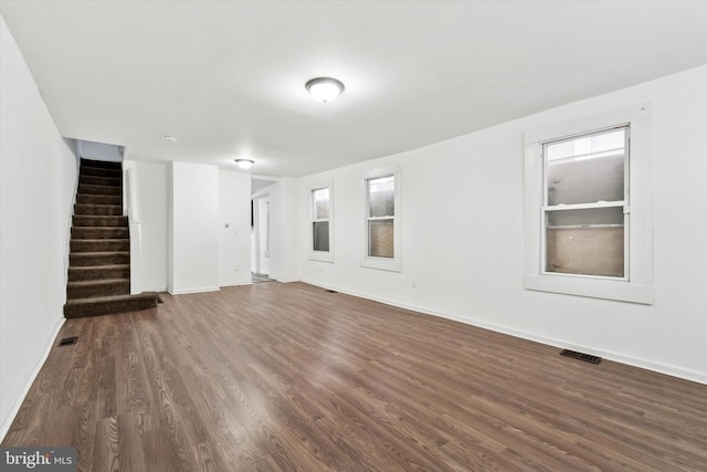 unfurnished living room featuring dark wood-type flooring