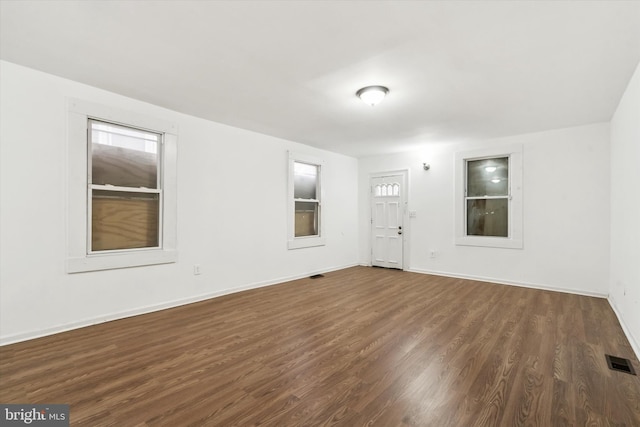 spare room featuring dark wood-type flooring