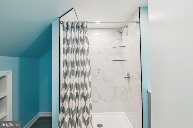 full bath with baseboards and a stall shower