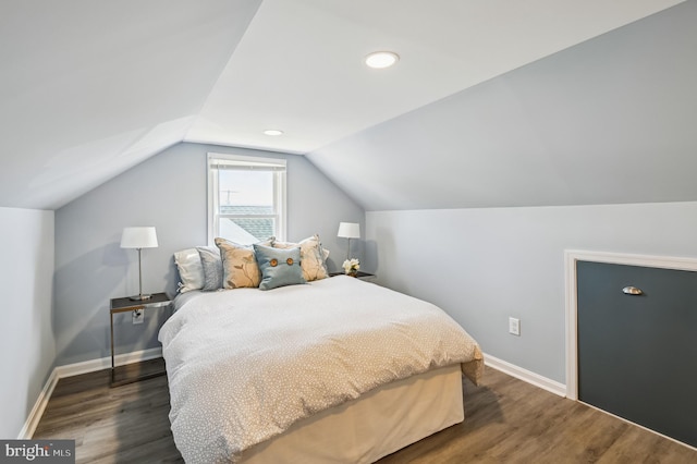 bedroom with dark wood finished floors, vaulted ceiling, recessed lighting, and baseboards