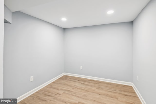 spare room featuring recessed lighting, baseboards, and light wood-type flooring