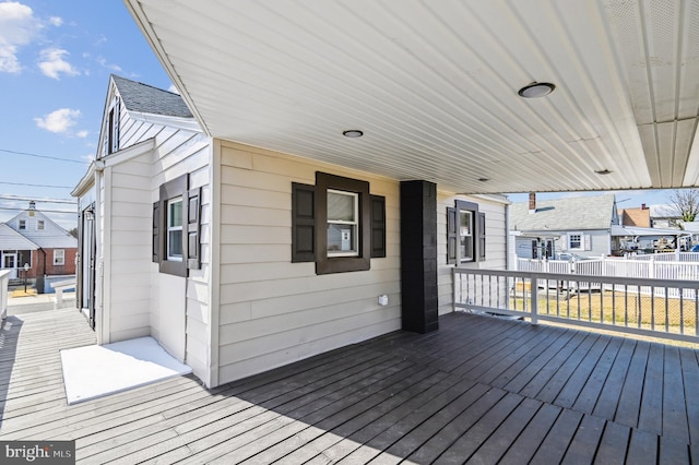 wooden deck featuring a residential view and fence