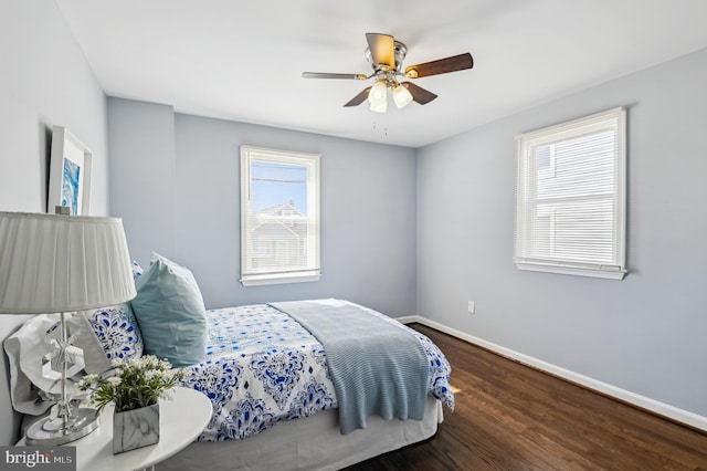 bedroom featuring a ceiling fan, baseboards, and wood finished floors