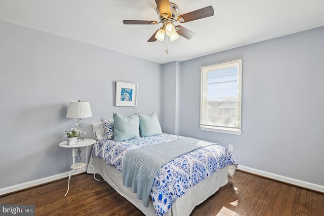 bedroom with ceiling fan, baseboards, and wood finished floors