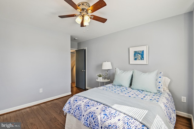 bedroom featuring ceiling fan, baseboards, and wood finished floors
