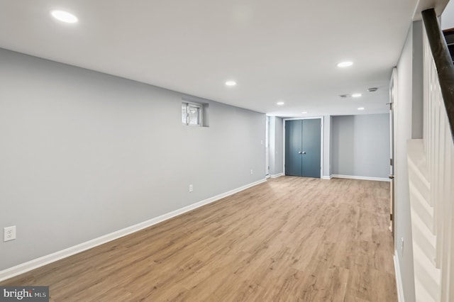 basement featuring recessed lighting, baseboards, and light wood finished floors