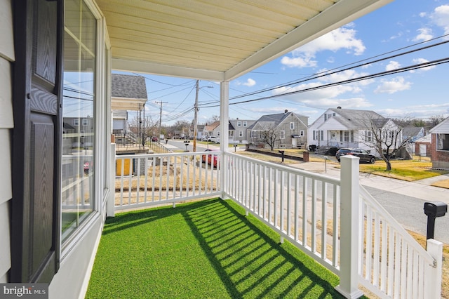 balcony featuring a residential view and a sunroom