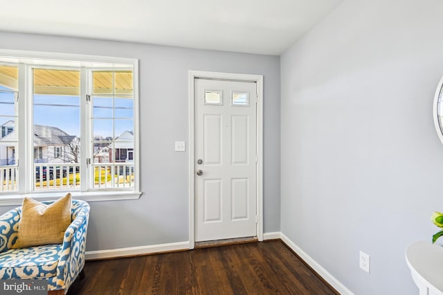 entrance foyer with dark wood-style floors and baseboards