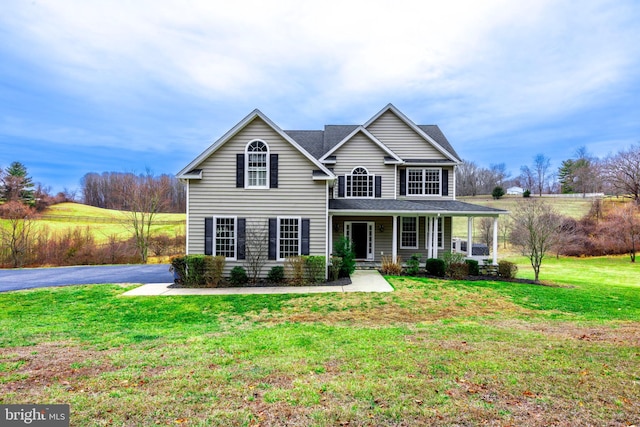 view of front facade with a porch and a front lawn