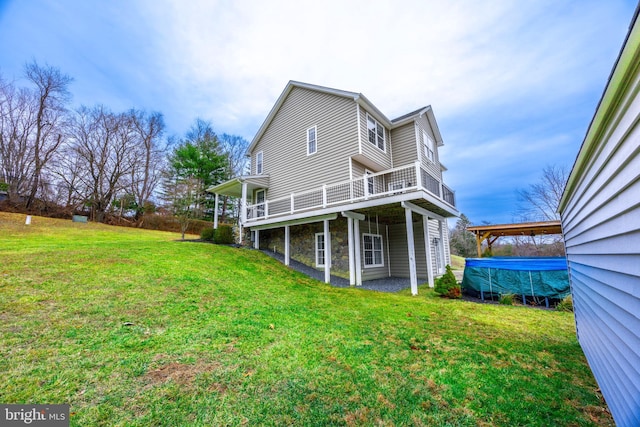 rear view of house with a wooden deck and a yard