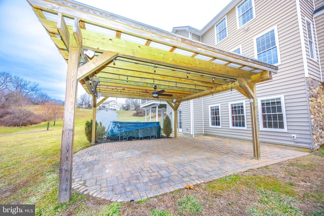 view of patio / terrace featuring ceiling fan and a shed