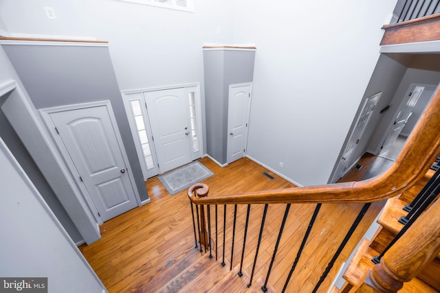 entrance foyer with a high ceiling and light wood-type flooring