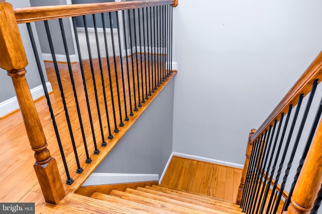 stairs featuring hardwood / wood-style flooring