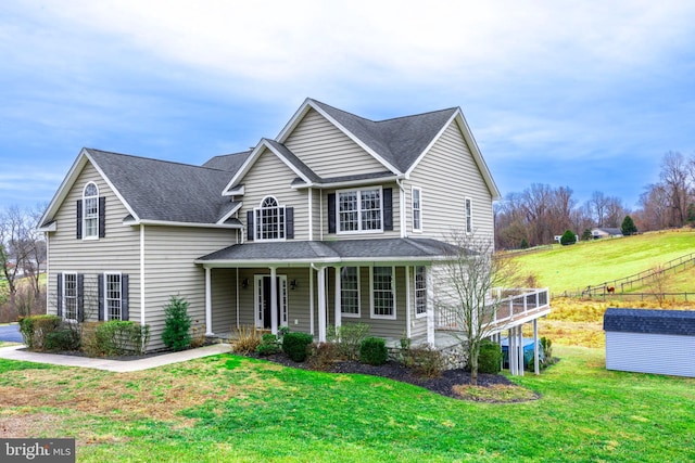 view of front property featuring a porch and a front lawn