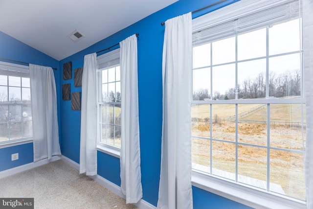 entryway with lofted ceiling and carpet