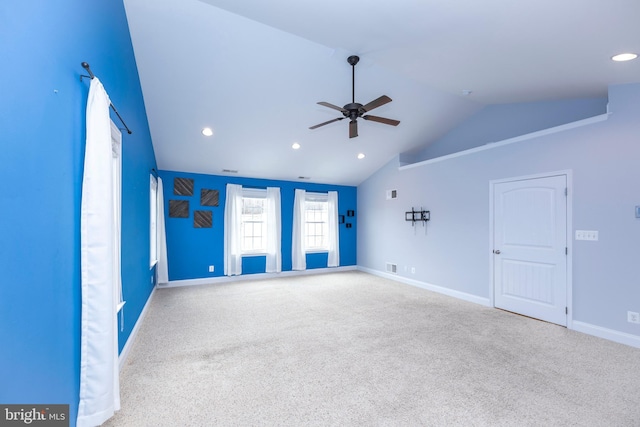 carpeted spare room with vaulted ceiling and ceiling fan