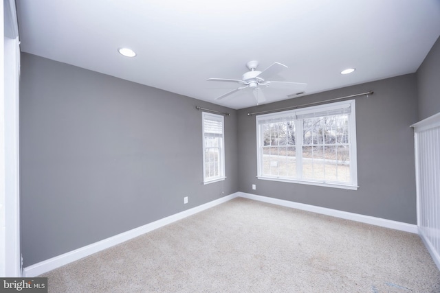 carpeted empty room featuring ceiling fan