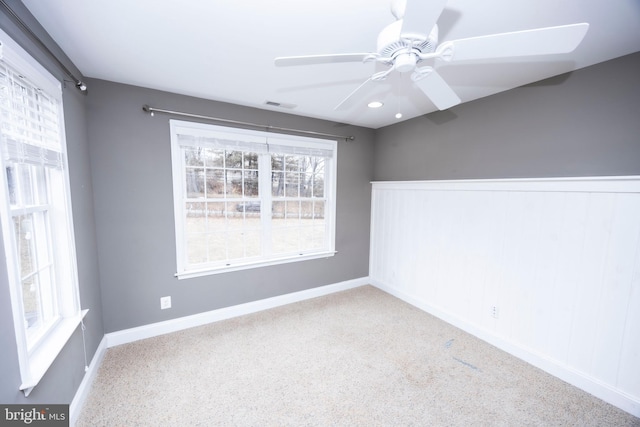 spare room featuring ceiling fan and light carpet