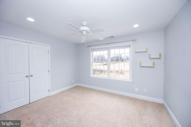 unfurnished bedroom featuring carpet floors, ceiling fan, and a closet