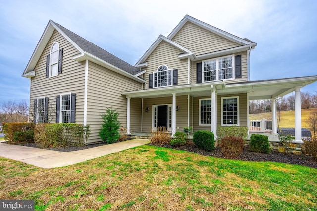 front of property with a front yard and a porch