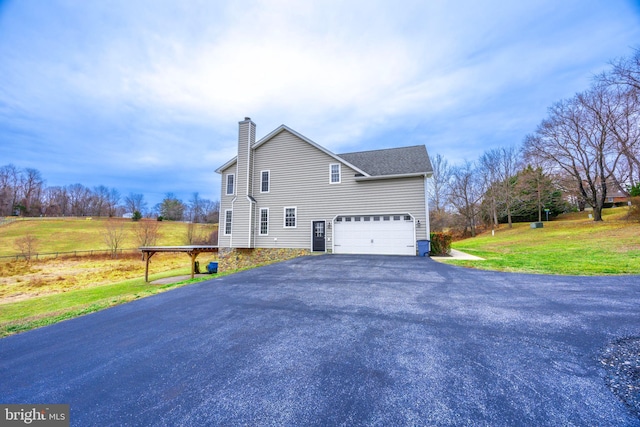 view of home's exterior with a yard and a garage