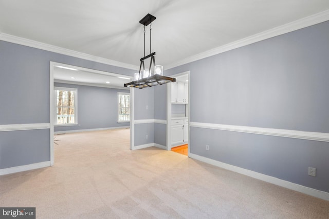 unfurnished dining area with light carpet, baseboards, and ornamental molding