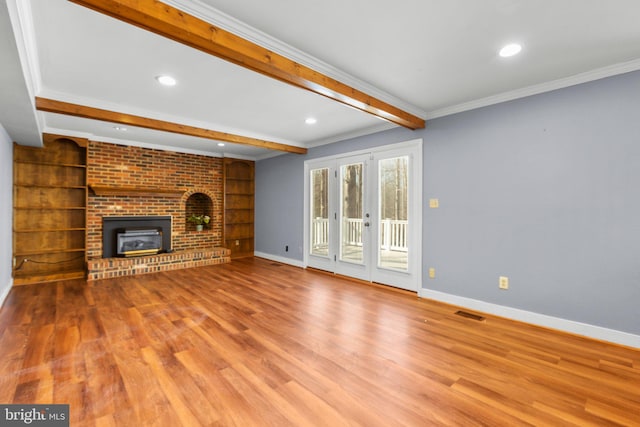 unfurnished living room with beam ceiling, crown molding, and baseboards