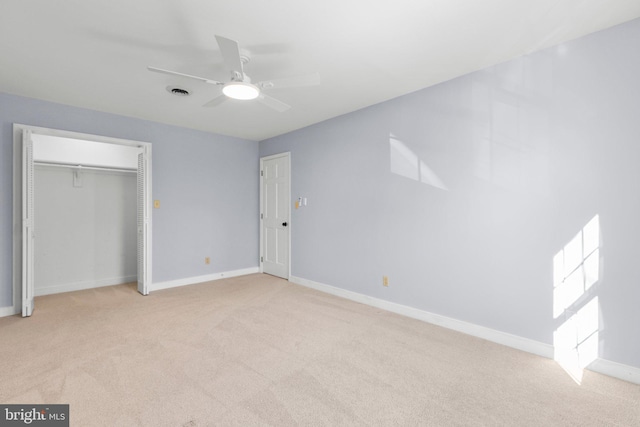 unfurnished bedroom with light carpet, a closet, visible vents, and baseboards