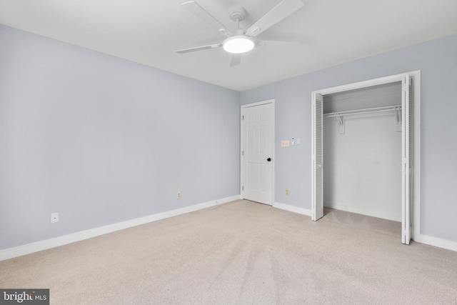 unfurnished bedroom featuring ceiling fan, baseboards, a closet, and light colored carpet