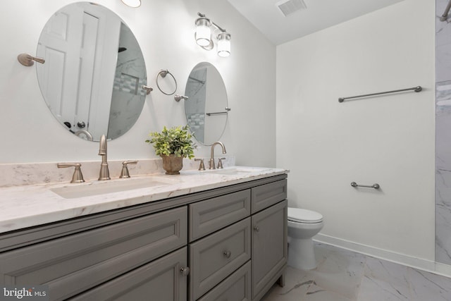 bathroom with marble finish floor, a sink, visible vents, and baseboards