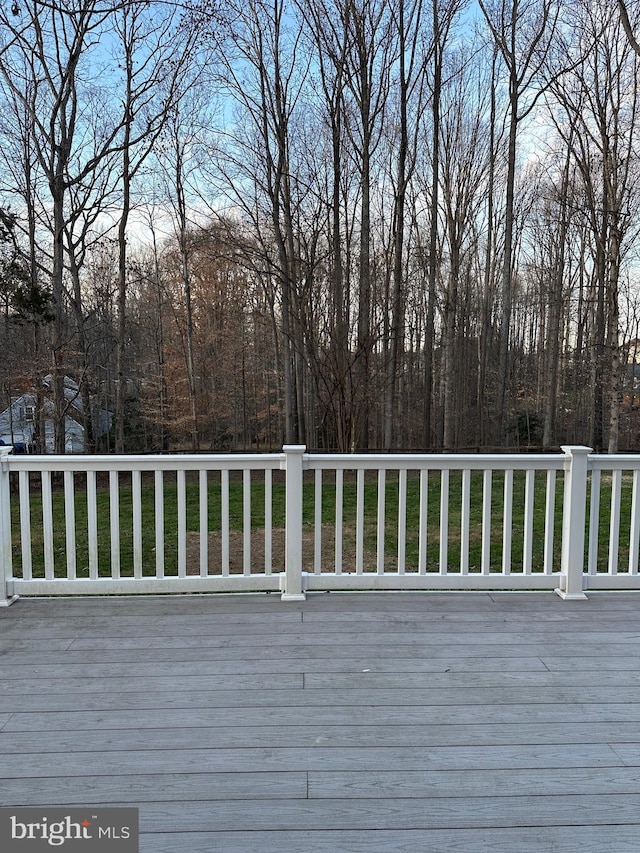 wooden deck with a lawn