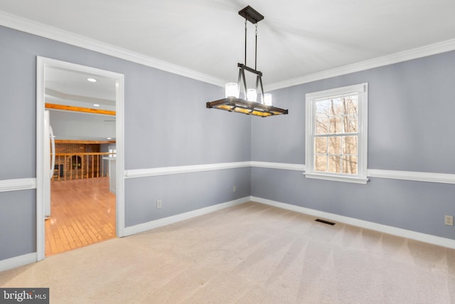 unfurnished room with light carpet, baseboards, visible vents, and ornamental molding