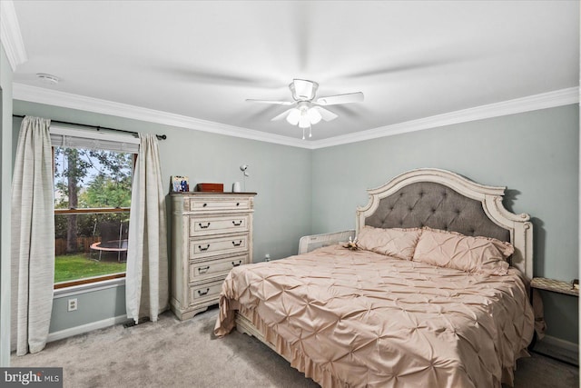 carpeted bedroom featuring crown molding and ceiling fan