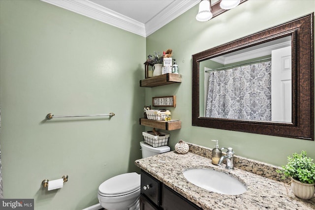 bathroom with crown molding, vanity, and toilet