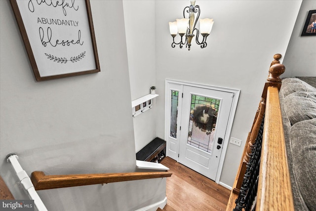 entryway featuring a notable chandelier and wood-type flooring