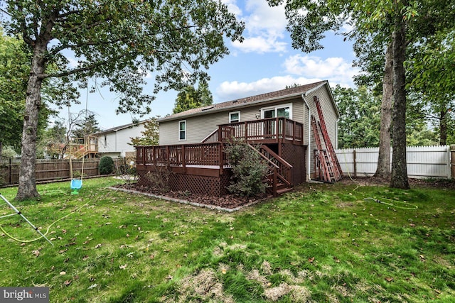 back of property featuring a yard and a deck