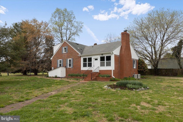 view of front facade featuring central AC unit and a front lawn