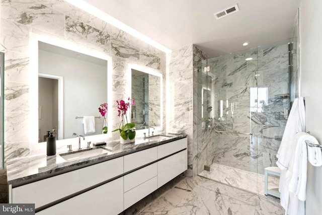 bathroom featuring vanity and a shower with shower door