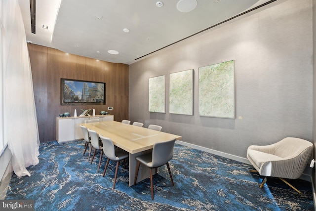 dining space with wooden walls