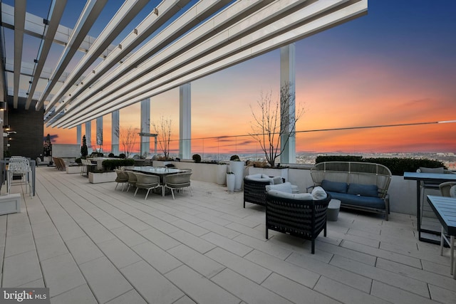 patio terrace at dusk featuring an outdoor living space and a pergola