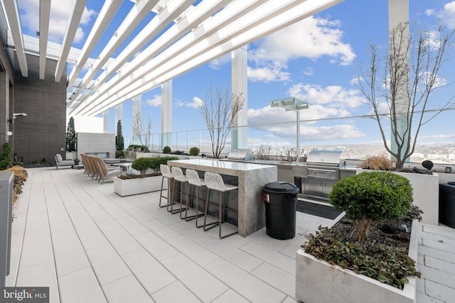 view of patio / terrace with area for grilling, a grill, a pergola, and an outdoor bar