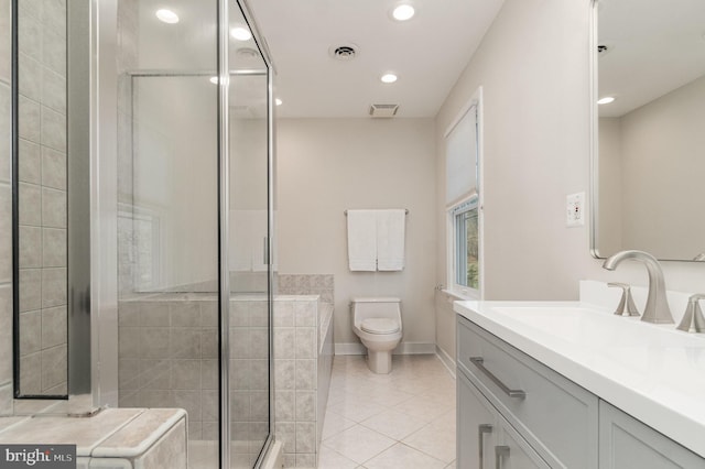 bathroom with tile patterned floors, toilet, an enclosed shower, and vanity