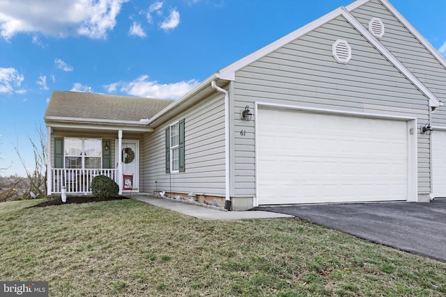 view of front of home with a porch, a garage, and a front lawn