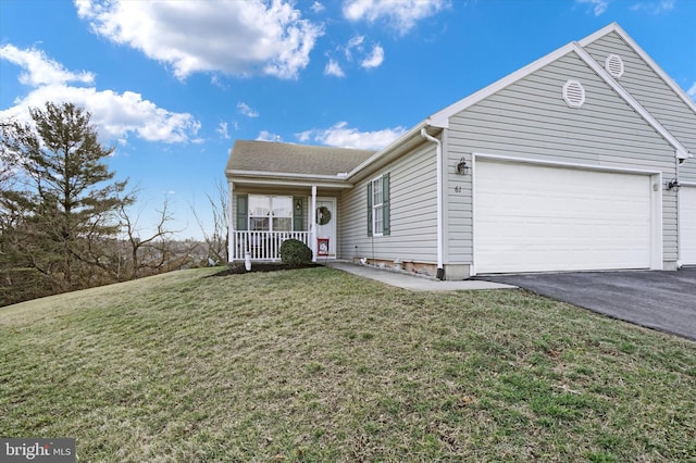 view of front facade with a garage, covered porch, and a front yard