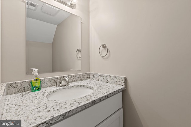 bathroom featuring vanity and vaulted ceiling