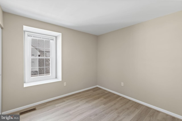 spare room with light hardwood / wood-style floors