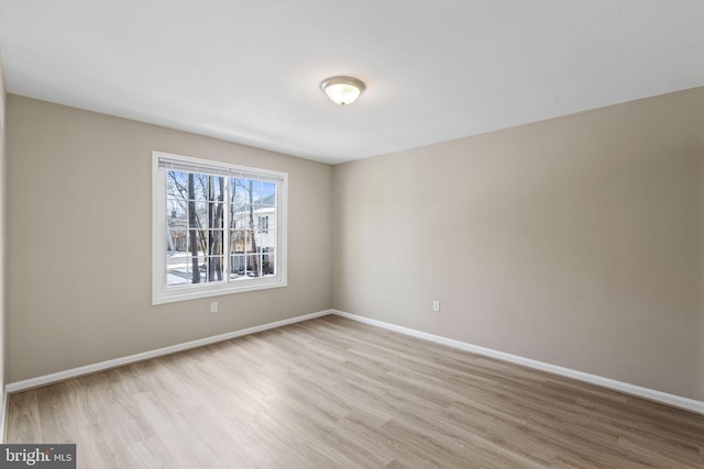 spare room with light hardwood / wood-style flooring