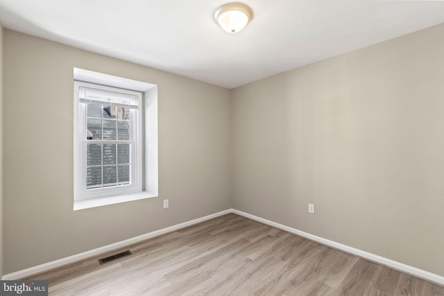 spare room featuring light hardwood / wood-style floors