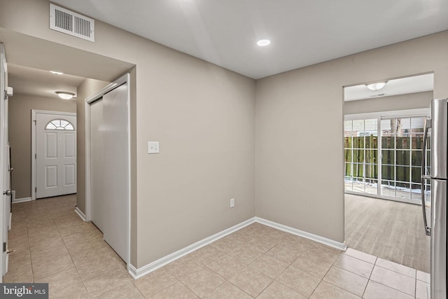 corridor with light tile patterned floors