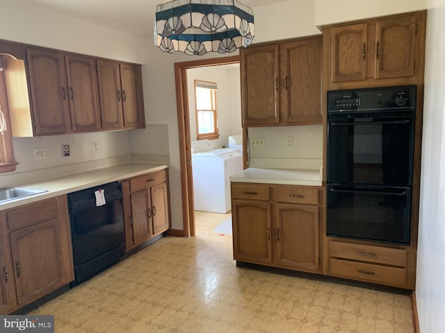 kitchen with separate washer and dryer and black appliances